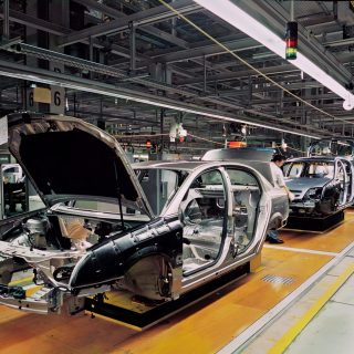 car production line with unfinished cars in a row